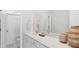 Clean bathroom with a white vanity, neutral walls, and a shower featuring a convenient shower curtain at 318 Archar St, Summerville, SC 29486