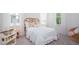 Bright bedroom with a woven headboard bed, natural light, and calming gray carpet, creating a serene atmosphere at 318 Archar St, Summerville, SC 29486