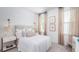 Cozy bedroom featuring a comfortable bed with stylish headboard, bright windows, and a neutral color palette at 318 Archar St, Summerville, SC 29486