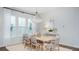 Bright dining room featuring a large window, modern lighting, and a neutral color palette at 318 Archar St, Summerville, SC 29486