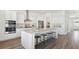 Bright kitchen with stainless steel appliances, large island with seating and hardwood flooring at 318 Archar St, Summerville, SC 29486