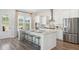 Bright kitchen with stainless steel appliances, a large island, and hardwood flooring at 318 Archar St, Summerville, SC 29486
