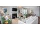 Spacious open-concept living room with fireplace, comfortable seating, and connection to dining area at 318 Archar St, Summerville, SC 29486