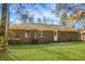 Brick exterior with lush backyard featuring a green lawn at 319 Bluebell Ave, Summerville, SC 29483