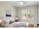Bright bedroom with a large window, ceiling fan and upholstered headboard at 319 Bluebell Ave, Summerville, SC 29483