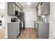Modern kitchen featuring sleek grey cabinets, stainless steel appliances, granite countertops, and hardwood flooring at 319 Bluebell Ave, Summerville, SC 29483
