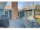 A view of the back deck, showing the chimney, a grill, and a screened-in porch at 32 Monte Sano Dr, Hanahan, SC 29410