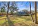 A picturesque view of the backyard with a screened pool nestled among the trees at 32 Monte Sano Dr, Hanahan, SC 29410