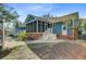A backyard patio with access to a screened-in porch and mature trees at 32 Monte Sano Dr, Hanahan, SC 29410