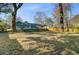 A sprawling backyard featuring a screened pool, framed by mature trees and lush greenery at 32 Monte Sano Dr, Hanahan, SC 29410