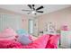 Bright and cheerful pink bedroom featuring a ceiling fan, closet, and vanity with soft, natural lighting at 32 Monte Sano Dr, Hanahan, SC 29410