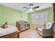 Adorable Bedroom with green walls, natural light, crib, ceiling fan, and charming Winnie the Pooh accents at 32 Monte Sano Dr, Hanahan, SC 29410