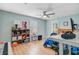 Light-filled bedroom with ceiling fan and hardwood floors showcasing organized shelving unit and gaming space at 32 Monte Sano Dr, Hanahan, SC 29410