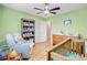 Bright Bedroom features a wood crib, rocking chair, open bookshelves, and plenty of toy storage at 32 Monte Sano Dr, Hanahan, SC 29410