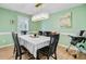Dining room with checkered tablecloth, modern lighting, and green walls at 32 Monte Sano Dr, Hanahan, SC 29410