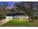 Charming single-story home featuring solar panels, a well-manicured lawn, and a welcoming front porch at 32 Monte Sano Dr, Hanahan, SC 29410
