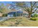 Inviting single-Gathering home with solar panels, a large yard, and a beautiful mature tree in front at 32 Monte Sano Dr, Hanahan, SC 29410