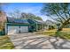 Charming single-story home with solar panels and a long driveway leading to a two-car garage at 32 Monte Sano Dr, Hanahan, SC 29410