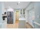 Modern kitchen with stainless steel appliances, island, white cabinets, and hardwood floors at 32 Monte Sano Dr, Hanahan, SC 29410