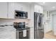 Updated kitchen features stainless steel appliances, white cabinets, granite countertops and tile backsplash at 32 Monte Sano Dr, Hanahan, SC 29410