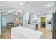 Open kitchen with white cabinets, stainless appliances, island, and hardwood floors at 32 Monte Sano Dr, Hanahan, SC 29410