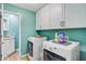 Well-organized laundry room featuring front-load washer/dryer, custom cabinets and a utility sink at 32 Monte Sano Dr, Hanahan, SC 29410