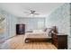Spacious main bedroom boasts hardwood floors, ceiling fan, and french doors with access to a balcony at 32 Monte Sano Dr, Hanahan, SC 29410