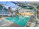 A clear in-ground pool surrounded by a screened enclosure is the centerpiece of the backyard at 32 Monte Sano Dr, Hanahan, SC 29410