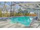 An in-ground pool with a screened enclosure, features a diving board and ladders for easy access at 32 Monte Sano Dr, Hanahan, SC 29410