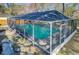 A view of the screened-in pool, with lush grass and mature trees surrounding it at 32 Monte Sano Dr, Hanahan, SC 29410