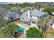 Stunning aerial view of backyard with pool and enclosed sunroom addition on this well-maintained two-story home at 3274 Heathland Way, Mount Pleasant, SC 29466