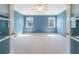 Light and airy carpeted bedroom with walk-in closet, french doors, and two windows with backyard views at 3274 Heathland Way, Mount Pleasant, SC 29466