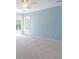 A bright bedroom features blue walls, two windows, and plush carpeting for a comfortable and inviting atmosphere at 3274 Heathland Way, Mount Pleasant, SC 29466