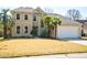 Charming two-story home featuring a manicured lawn, attached two car garage, and lush landscaping with palm trees at 3274 Heathland Way, Mount Pleasant, SC 29466
