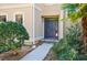 The front of this home is adorned with lush landscaping that frames a pathway to a freshly painted entry door at 3274 Heathland Way, Mount Pleasant, SC 29466