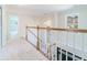 Bright hallway on the second floor with white carpet and white railings at 3274 Heathland Way, Mount Pleasant, SC 29466