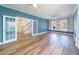 Spacious living room with hardwood floors, double french doors, custom built-in shelving, and lots of light at 3274 Heathland Way, Mount Pleasant, SC 29466