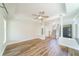 Large living room with hardwood floors, fireplace, crown molding, and staircase with traditional spindles at 3274 Heathland Way, Mount Pleasant, SC 29466