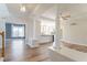 An open-concept living room with hardwood floors, decorative columns, and ample natural light offers a stylish living space at 3274 Heathland Way, Mount Pleasant, SC 29466