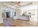 A spacious living room features hardwood floors, decorative columns, an adjacent kitchen, and ample natural light at 3274 Heathland Way, Mount Pleasant, SC 29466