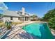 A backyard showcases a sparkling pool with a concrete deck, lush landscaping, and a privacy fence, ideal for outdoor enjoyment at 3274 Heathland Way, Mount Pleasant, SC 29466