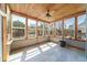 Bright sunroom with tile floors, wood ceiling, and many windows overlooking backyard and lush landscaping at 3274 Heathland Way, Mount Pleasant, SC 29466