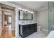 Bright bathroom features double sinks, modern fixtures, and a glass-enclosed shower at 35 Cypress St, Charleston, SC 29403