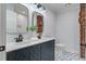 Updated bathroom with patterned tile floor, double sinks, and brick accent wall at 35 Cypress St, Charleston, SC 29403