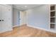 Bright, empty bedroom with hardwood floors and a walk in closet with brick accent wall at 35 Cypress St, Charleston, SC 29403