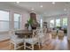Open-concept dining area with fireplace and hardwood flooring at 35 Cypress St, Charleston, SC 29403