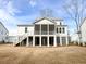 Rear exterior showcasing a screened porch and covered area with access to the elevated backyard at 3853 Delinger Dr, Mount Pleasant, SC 29466