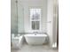 Modern bathroom featuring a standalone tub next to a large window with wooded views at 3853 Delinger Dr, Mount Pleasant, SC 29466