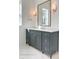 Bathroom vanity featuring marble countertop, gray cabinets, and sconce lighting at 3853 Delinger Dr, Mount Pleasant, SC 29466