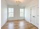 Bedroom with hardwood floors, white trim, closet, and abundant natural light at 3853 Delinger Dr, Mount Pleasant, SC 29466